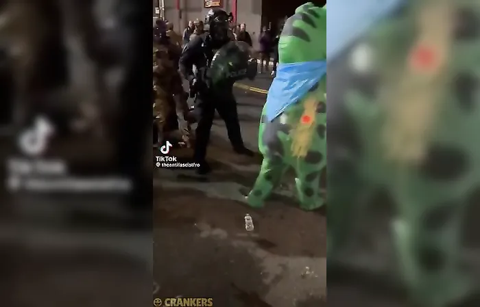 Officers sprays mace in the air vent of a costume wearing Antifa member in Portland