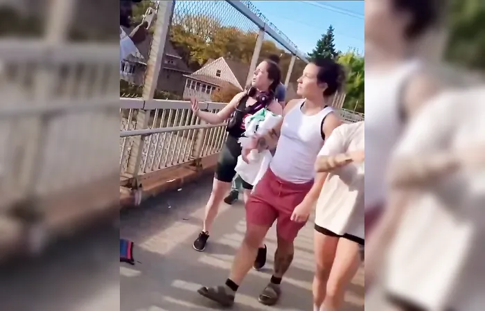 Group of feminists try destroying an American flag