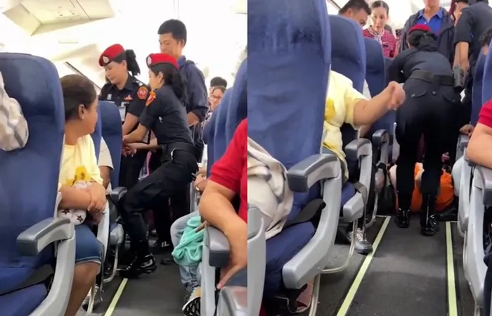 Large 'Man Child' in Garfield shirt dragged off a plane