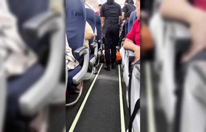 Large 'Man Child' in Garfield shirt dragged off a plane