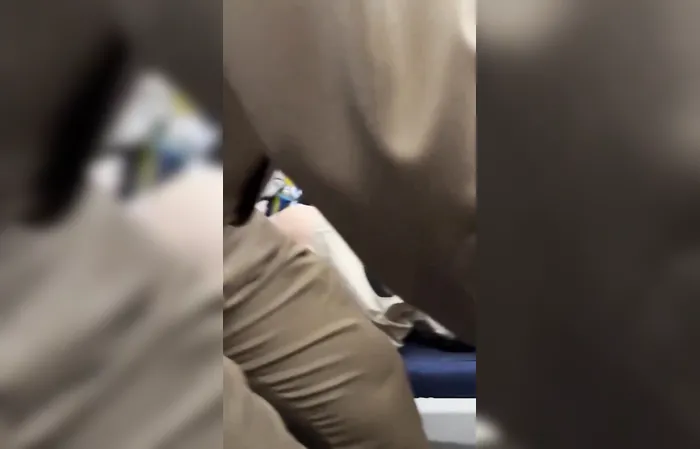 Large 'Man Child' in Garfield shirt dragged off a plane
