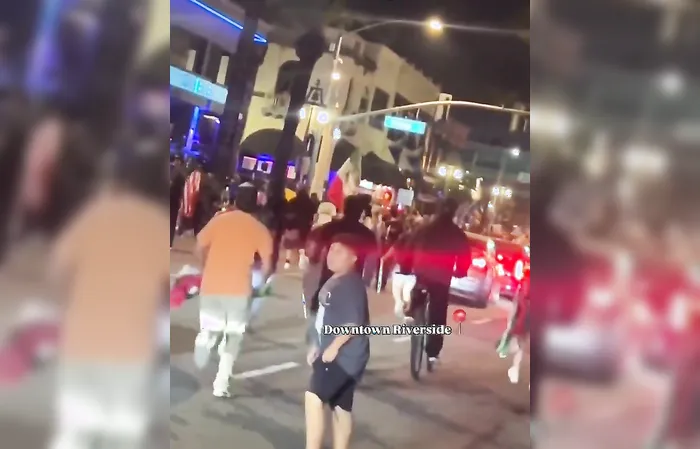 Rioters attack car, driver speeds up and hits someone while trying to escape