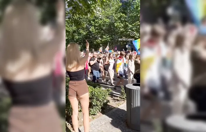 Woman shows one-handed gesture to protesters