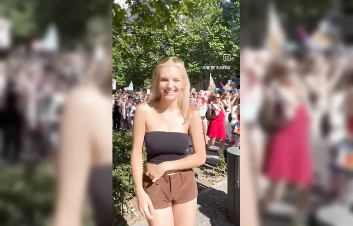 Woman shows one-handed gesture to protesters
