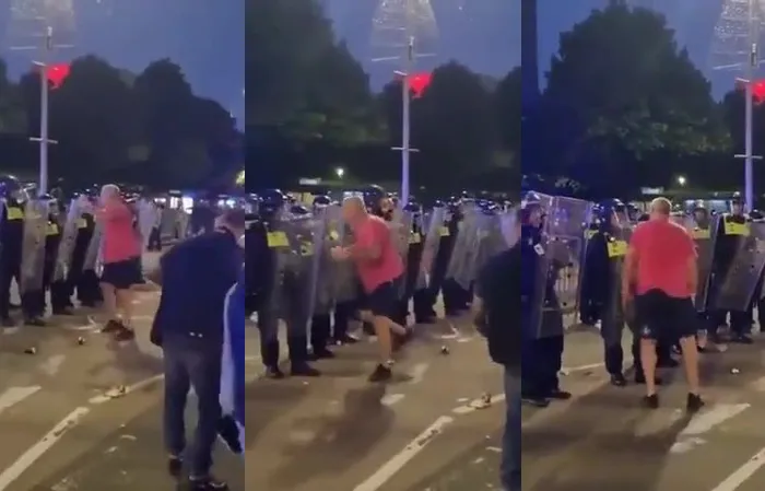 Cop gives protester a face full of riot shield