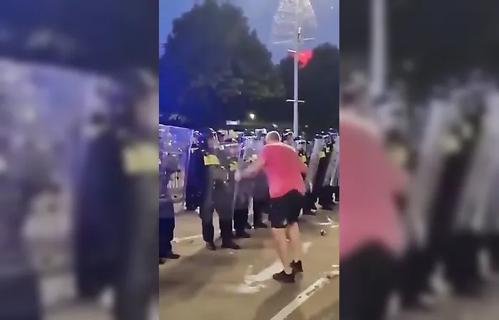 Cop gives protester a face full of riot shield