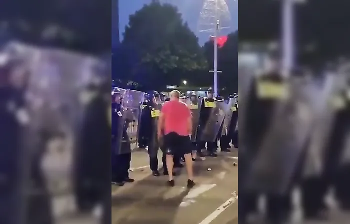 Cop gives protester a face full of riot shield