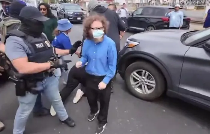 Protesters jump on ICE vehicle, clash with officers