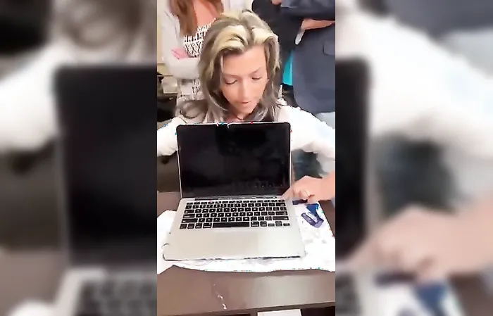 Woman ruins a MacBook by dipping it in water for a vinyl skin