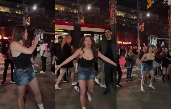College girl does backflip in the streets, top falls down