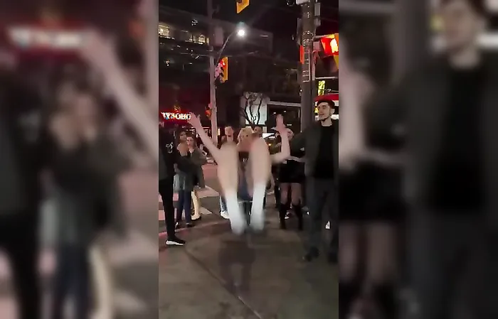 College girl does backflip in the streets, top falls down