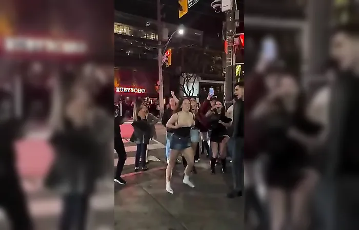 College girl does backflip in the streets, top falls down