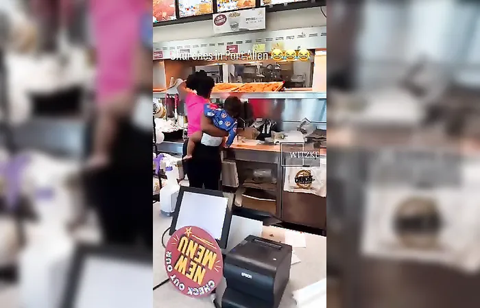 Woman goes behind counter to take chicken, uses baby as human meat shield