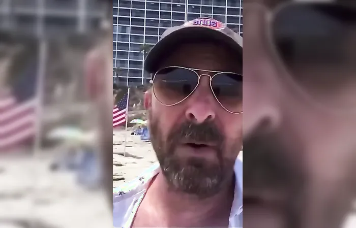 Guy gets triggered over American flags on the beach