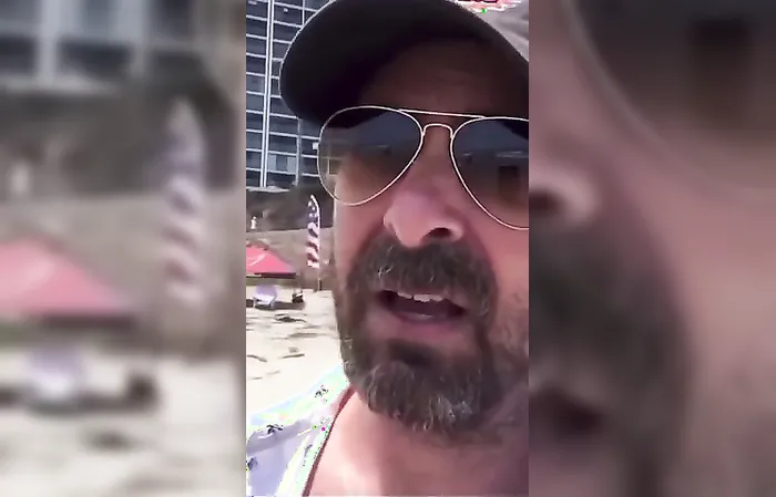 Guy gets triggered over American flags on the beach