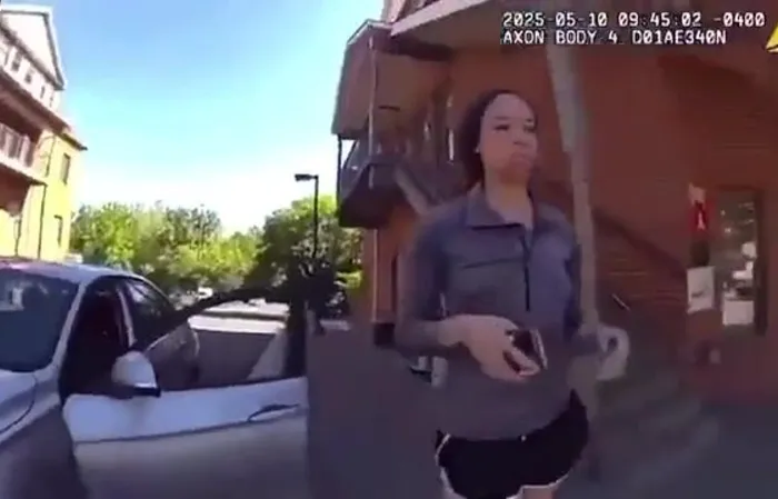 Woman drives through a festival to get to work