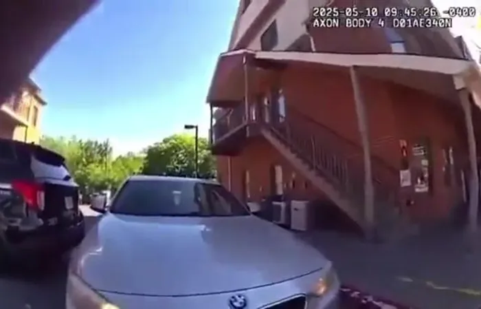 Woman drives through a festival to get to work