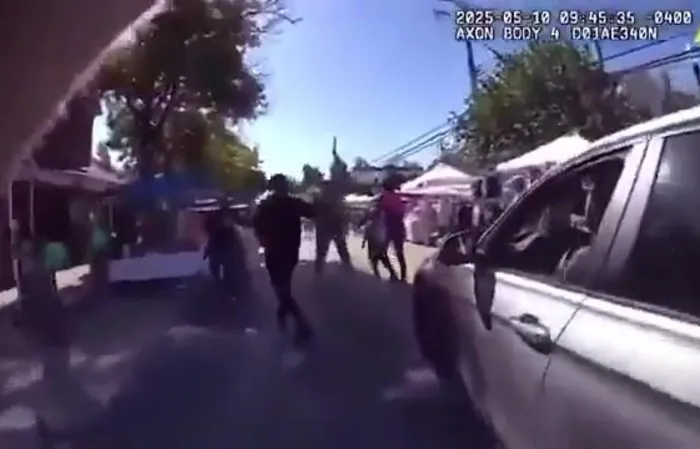 Woman drives through a festival to get to work