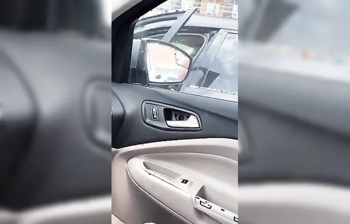 Woman kicking car door of a mom with kids