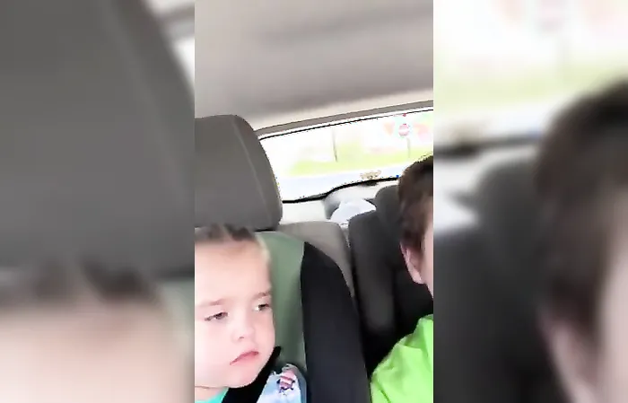 Woman kicking car door of a mom with kids