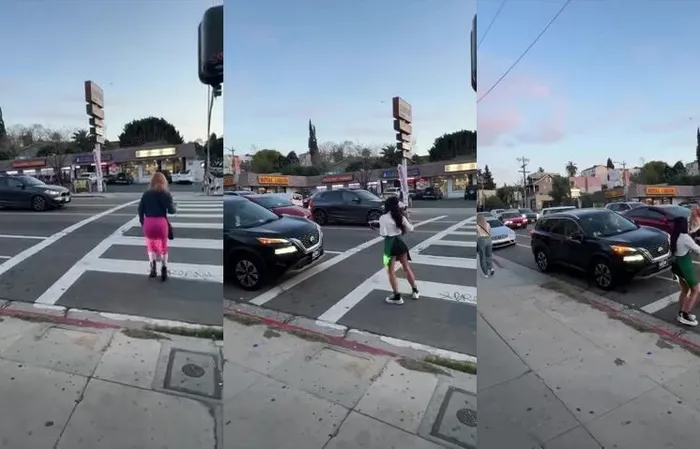 Group of women throw drinks at car in traffic