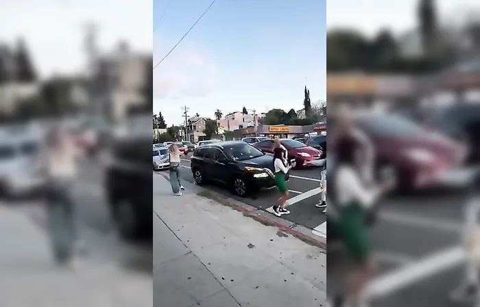 Group of women throw drinks at car in traffic