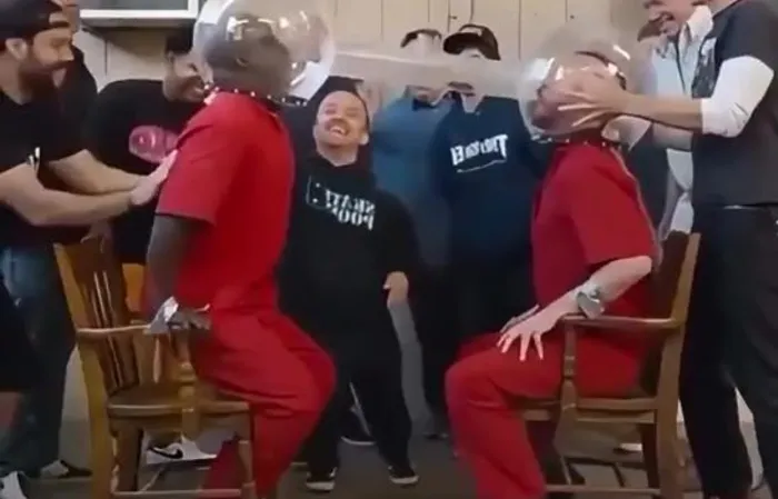 Guys try to blow spiders into each other's mouth