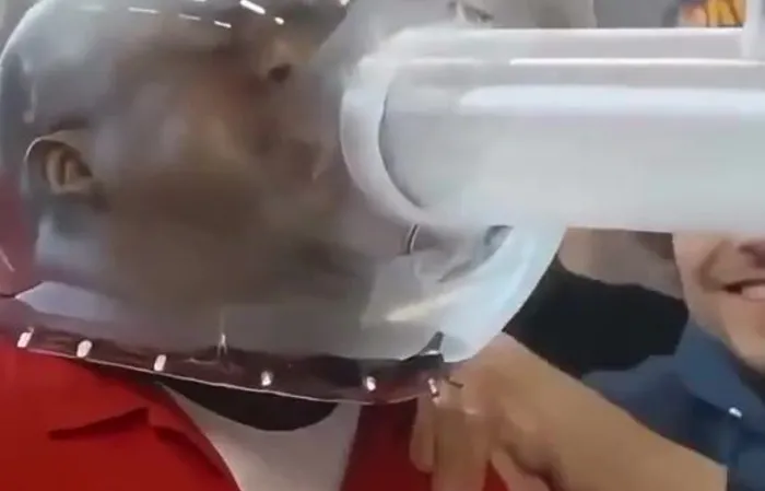 Guys try to blow spiders into each other's mouth