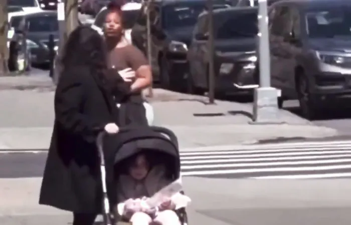 Spits at woman and child for no reason